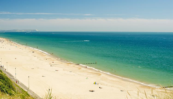 A beautiful beach from an angle showcasing the blue and aqua sea and golden sands